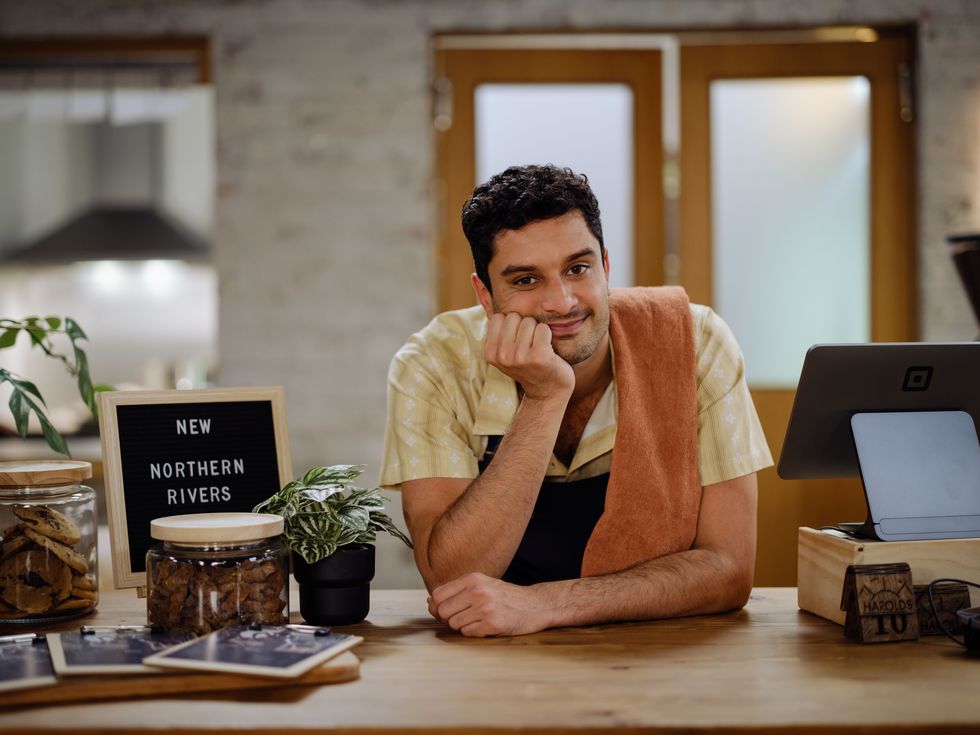 Haz is the new owner of Harold's and he leans on the counter with a towel over his shoulder
