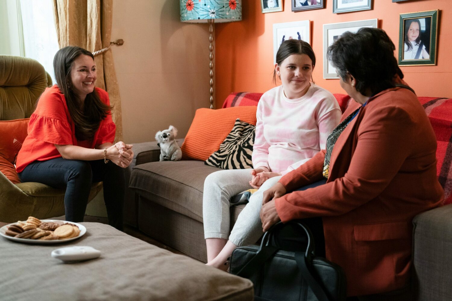 EastEnders' Stacey and Lily are smiling at the social worker whilst at home