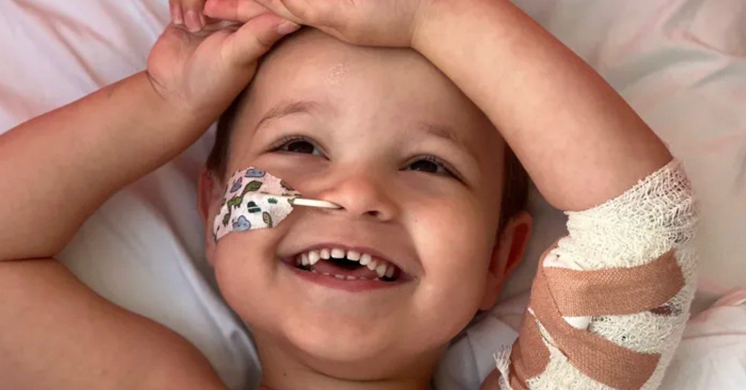 Dillan laying in hospital undergoing cancer treatment