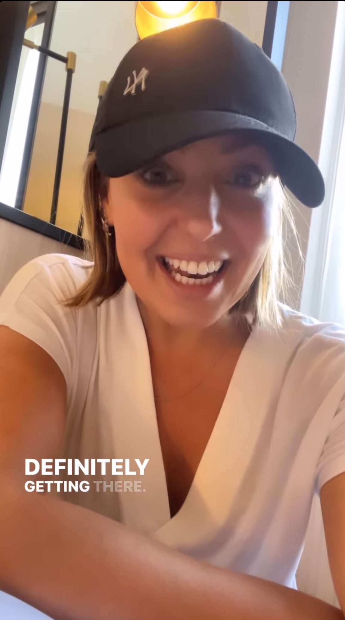 Amy Dowden in a baseball cap smiling