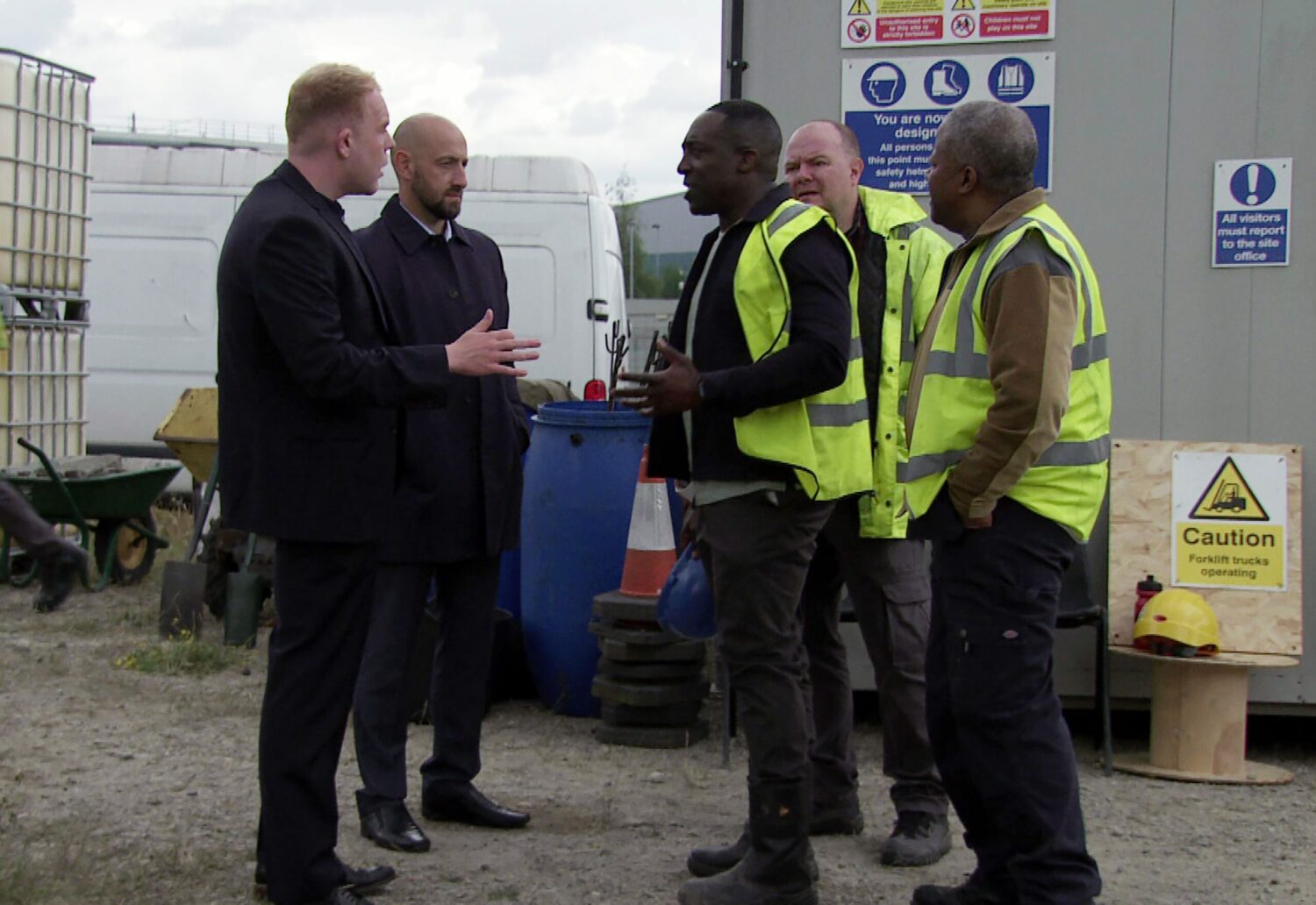 Craig and his police officer colleague talk to Ronnie and Ed at the building site in Corrie