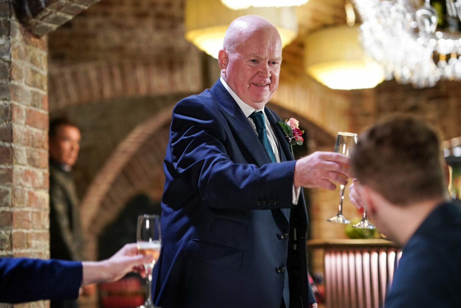 Phil toasts the Mitchell men in his wedding suit in EastEnders