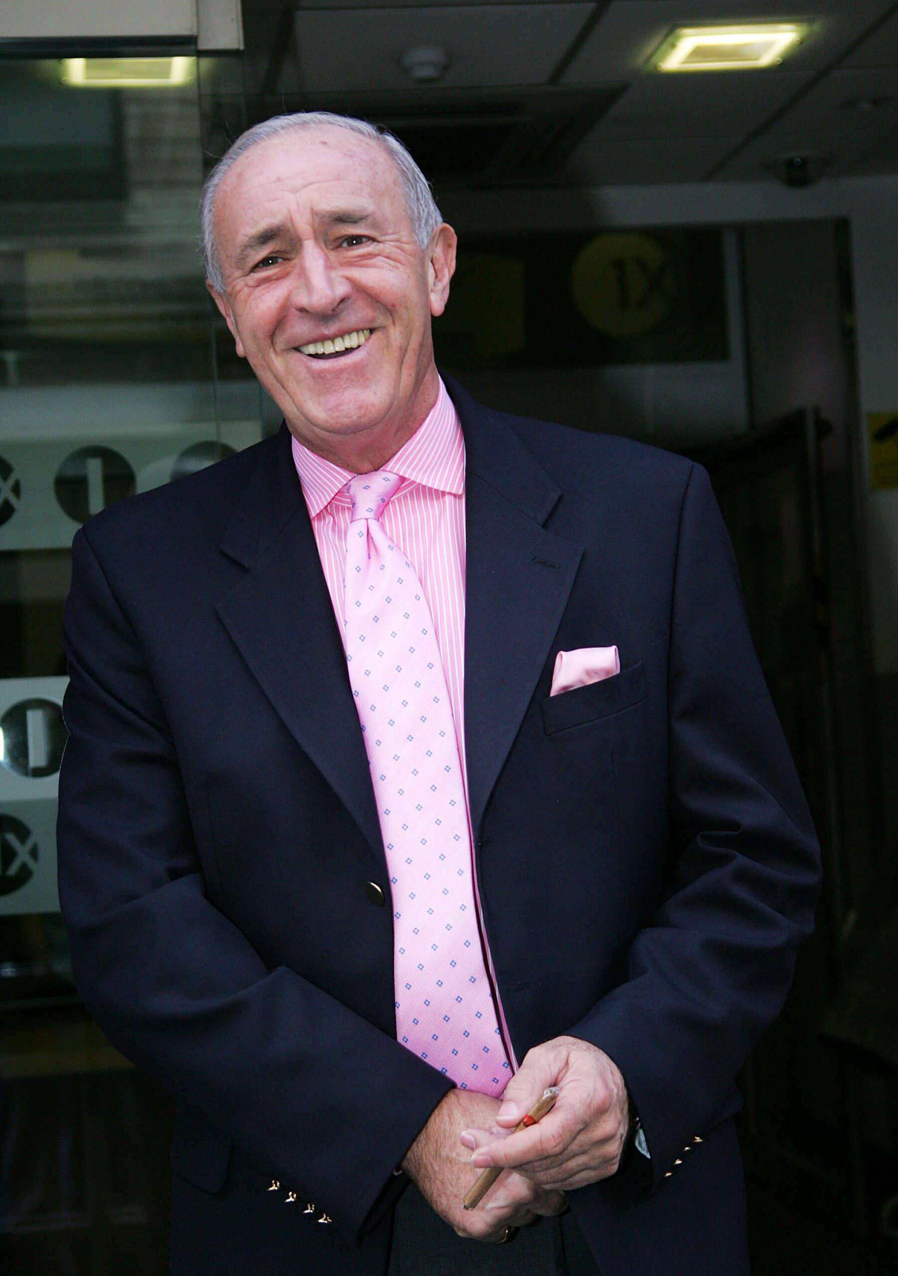 Len Goodman smiling in a pink shirt