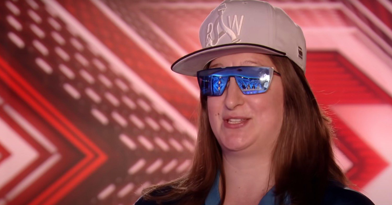 Honey G wearing a cap and sun glasses at her X Factor audition