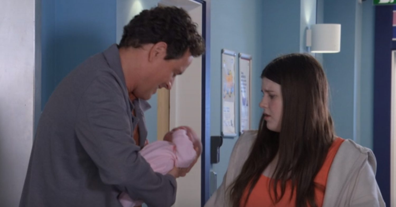 EastEnders' Theo is holding Charli whilst Lily is next to them at the hospital