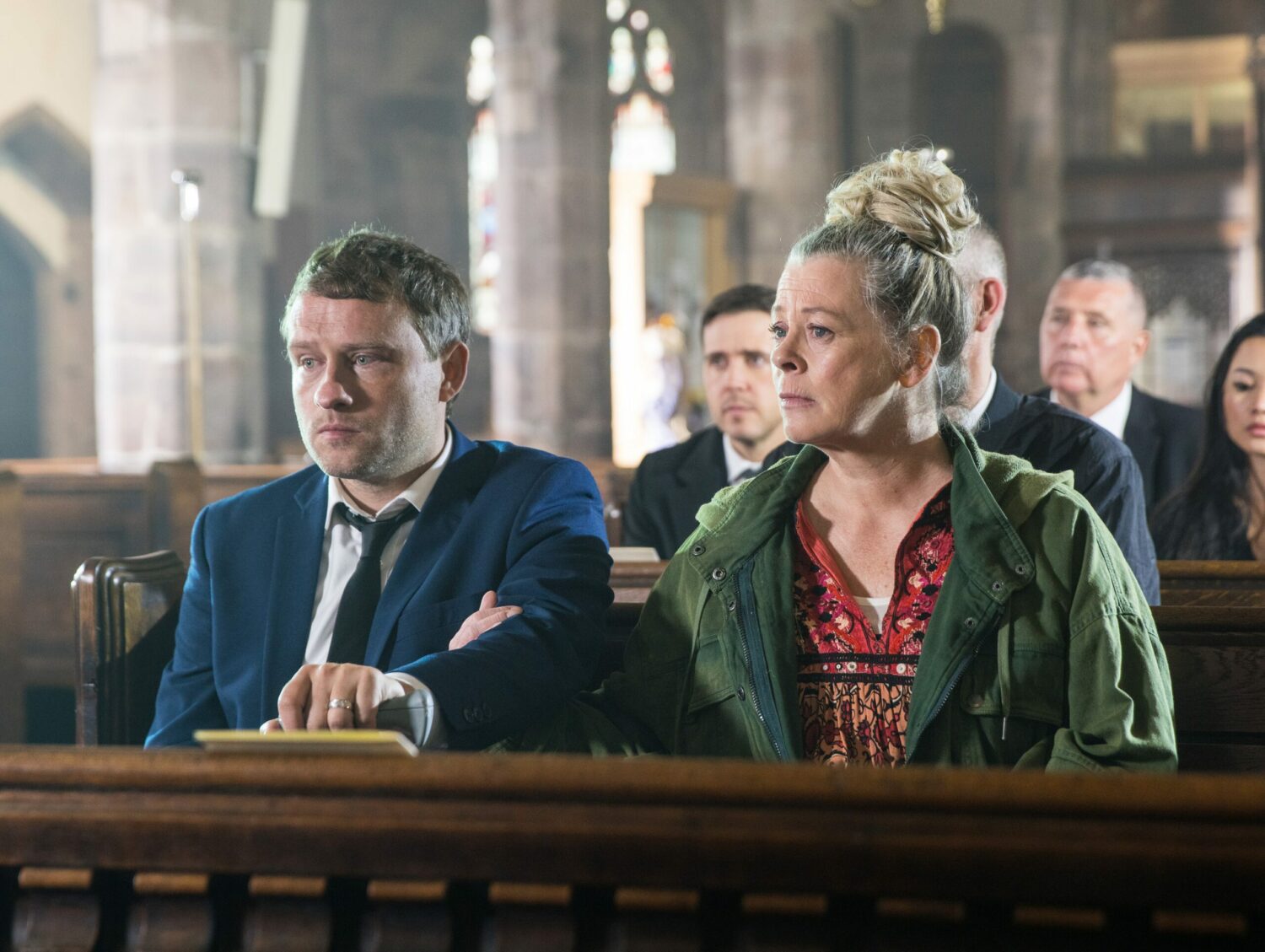 Paul and Bernie in Coronation Street look upset in the church
