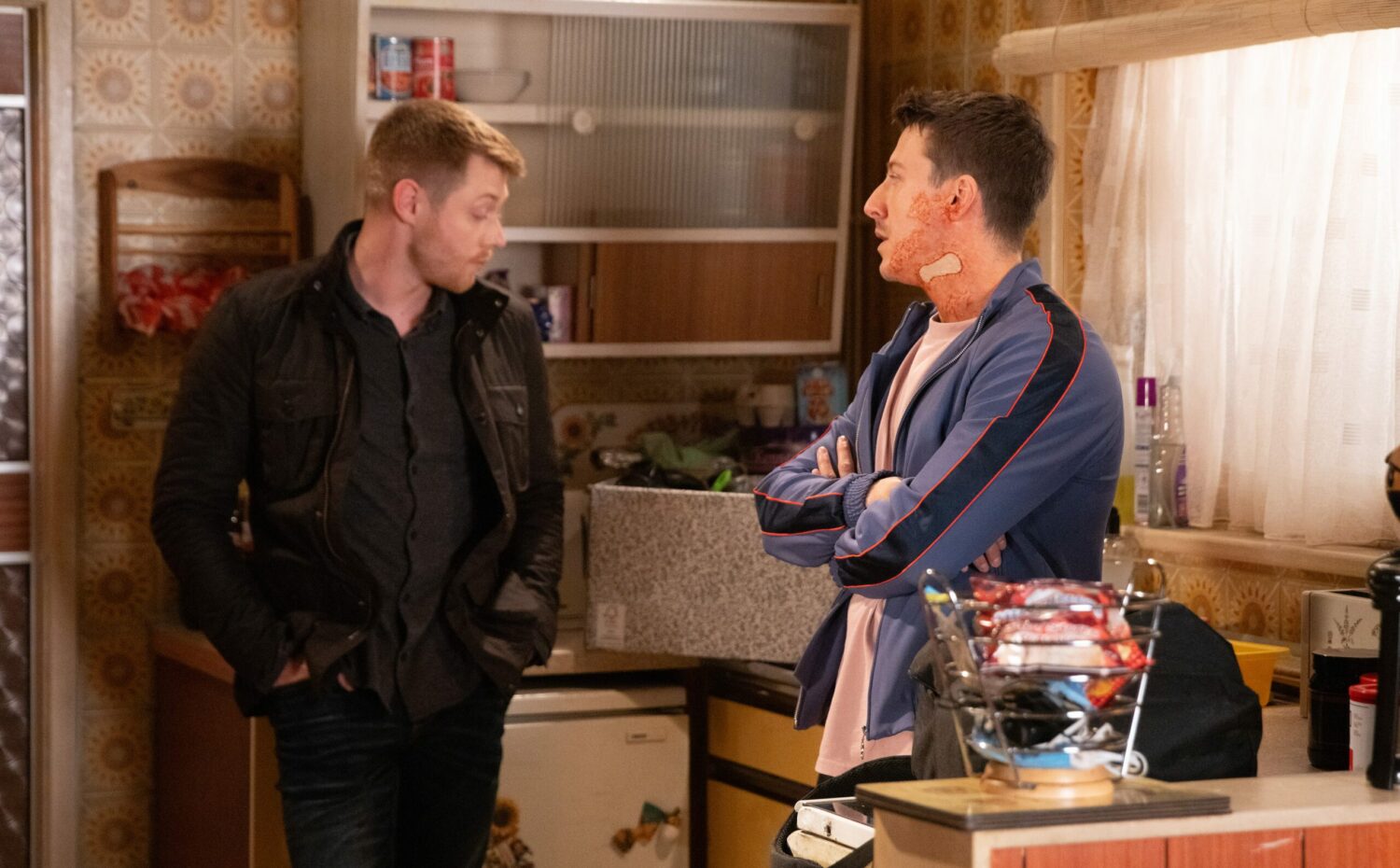 Daniel and Ryan stand in the kitchen and talk seriously in Coronation Street