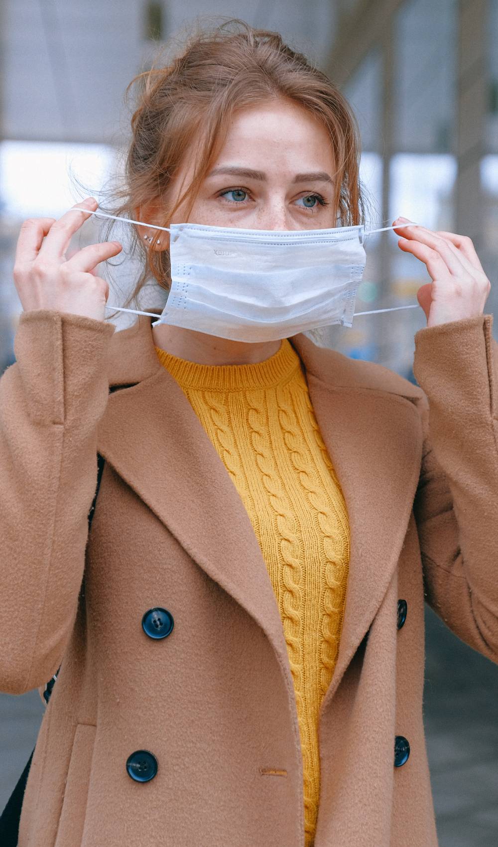 A woman puts on a mask