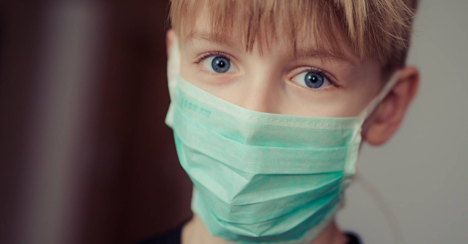 Child wears a mask