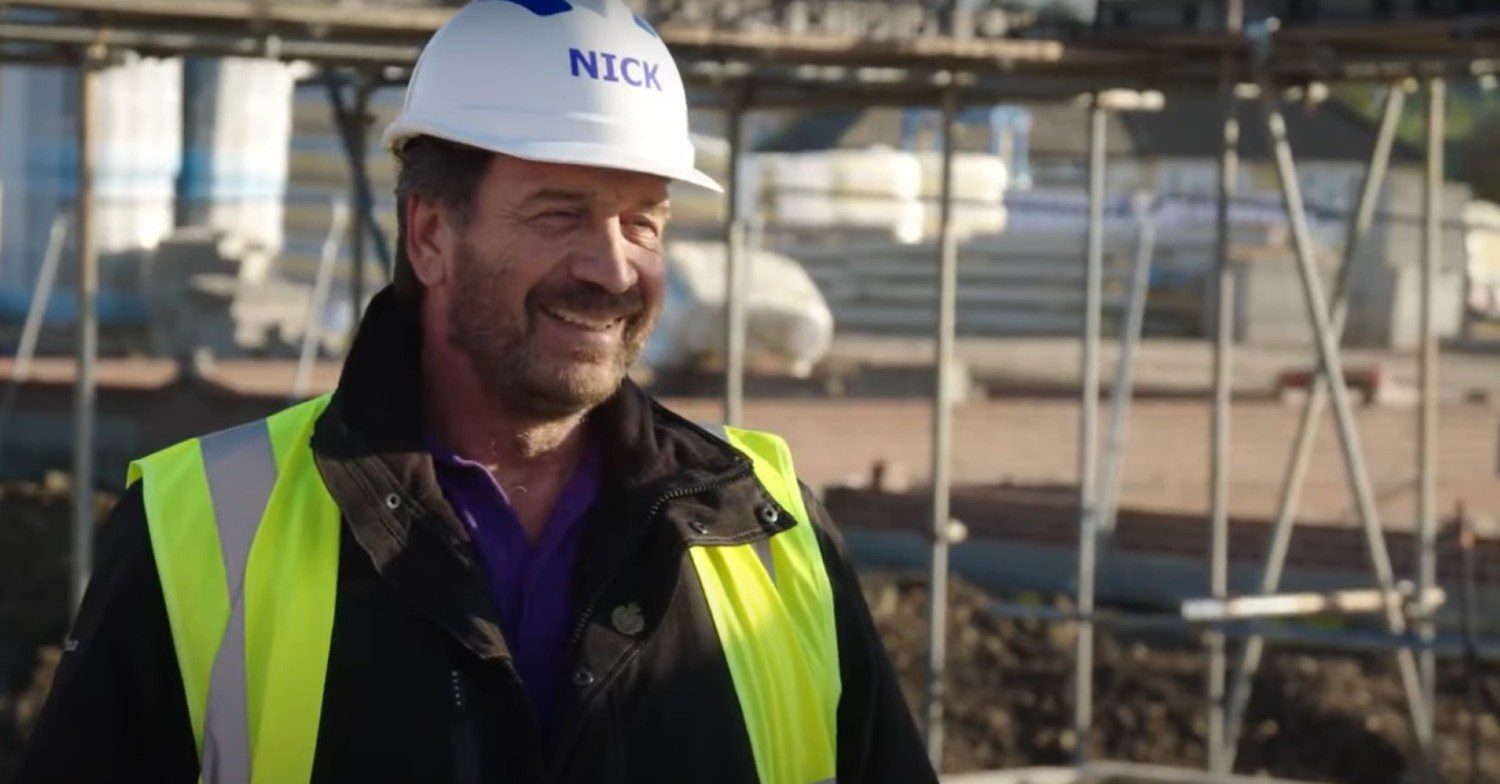 Nick Knowles wearing a hard hat while working on the TV show DIY SOS