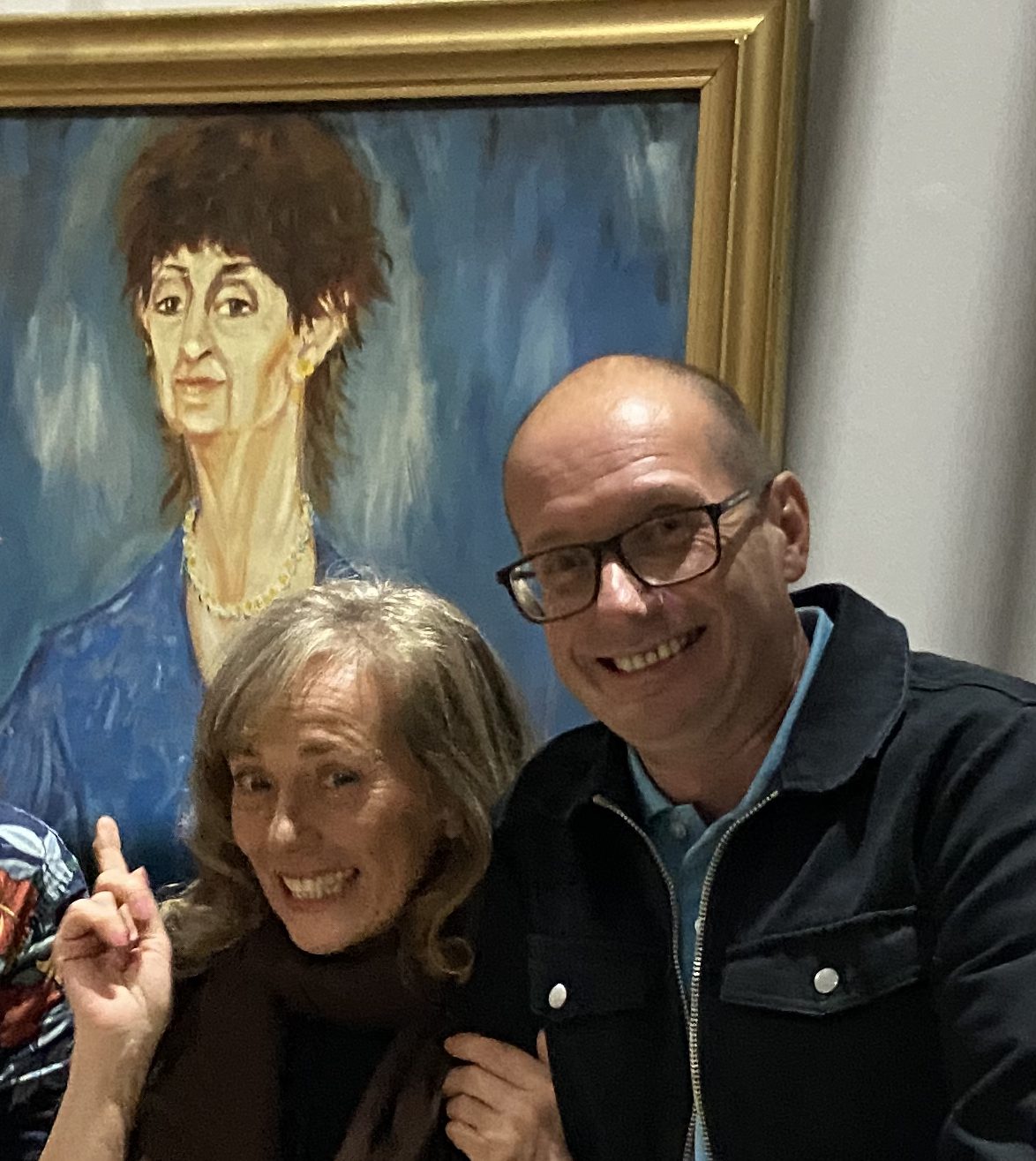 Jane Harris and Steven Murphy smile and point to Mrs Mangel's painting