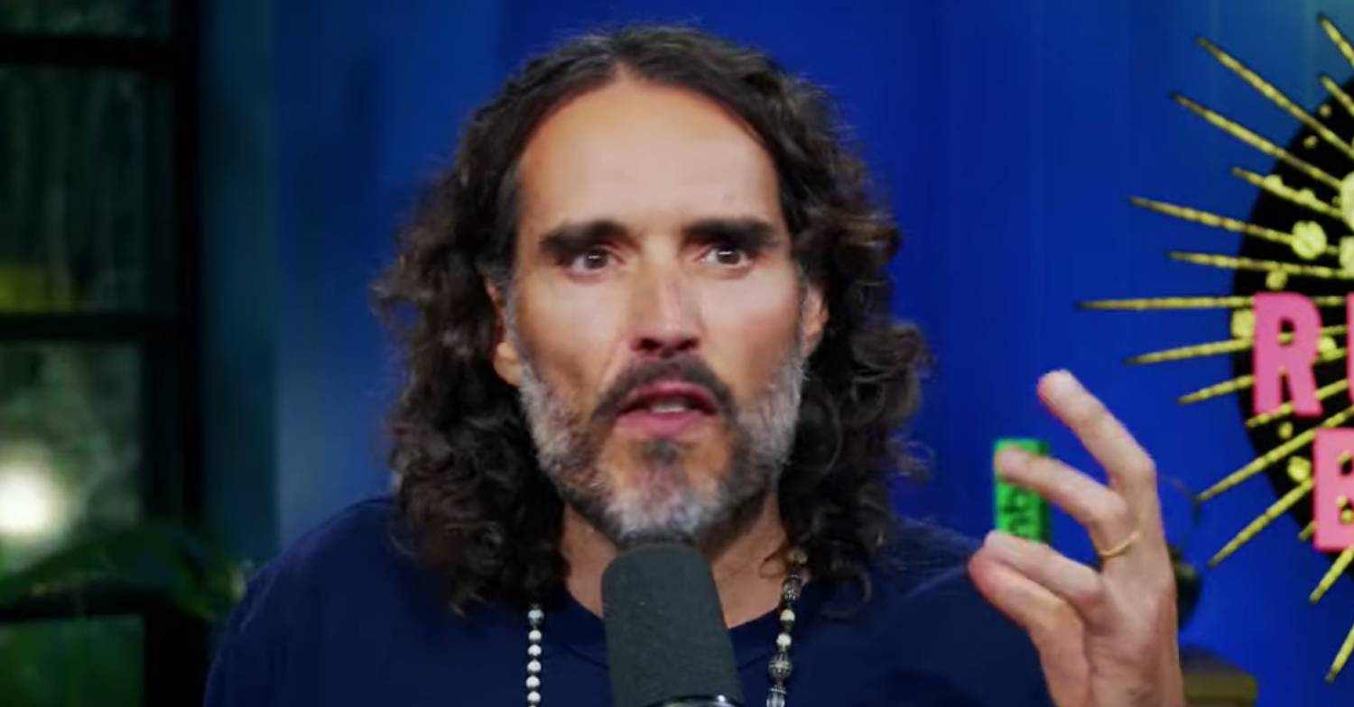 Russell Brand holds up his hand