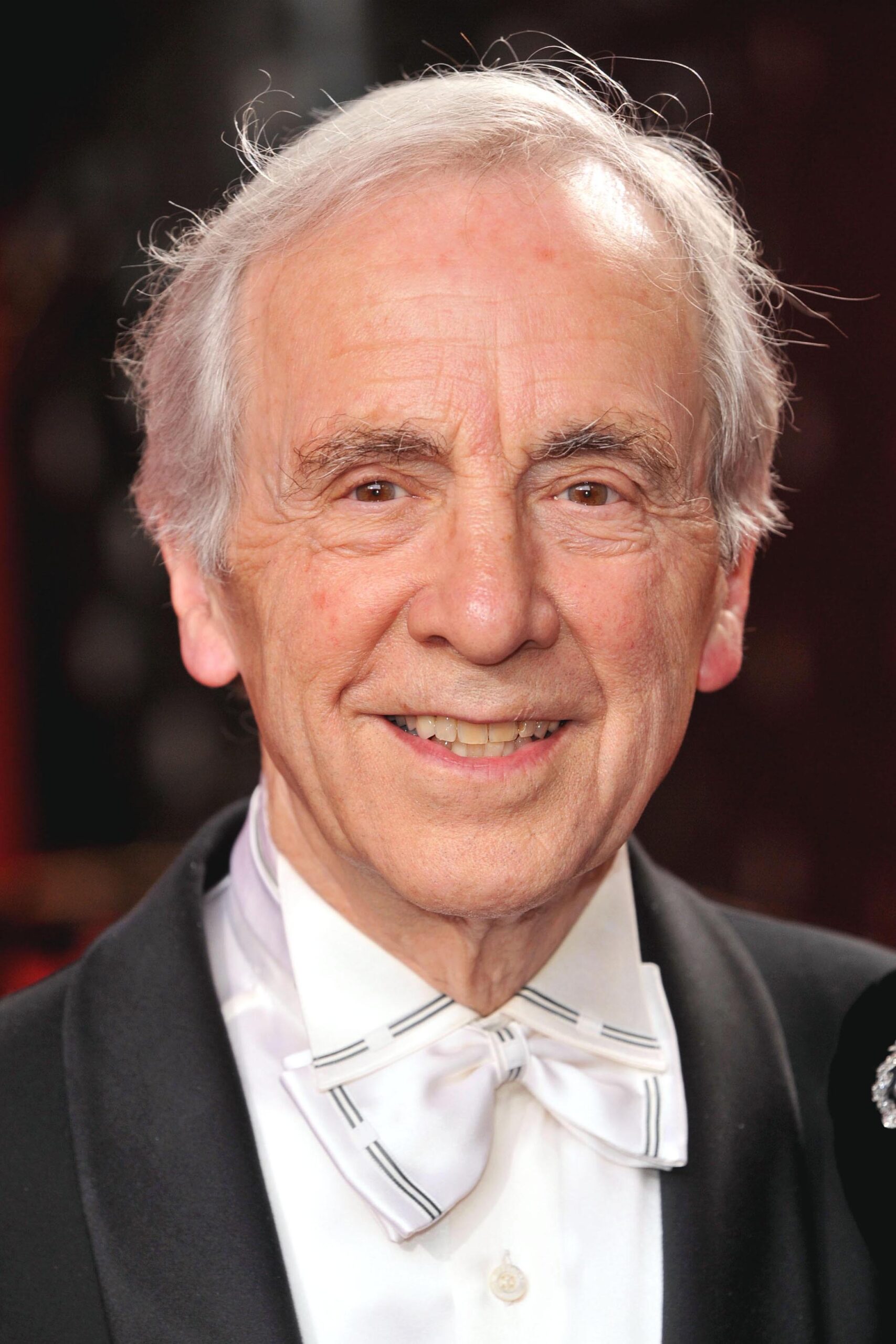 Andrew Sachs smiles on the red carpet at the BSAs