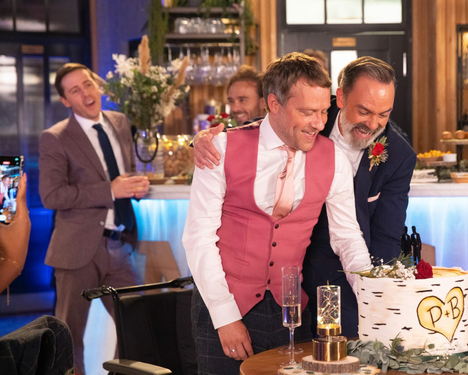 Todd watches on as joyful Paul and Billy cut the cake in Corrie