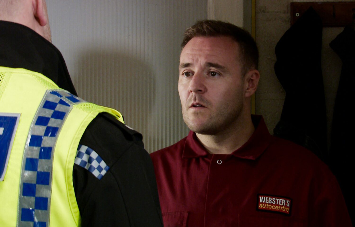 Tyrone Dobbs looks shocked as the police talk to him