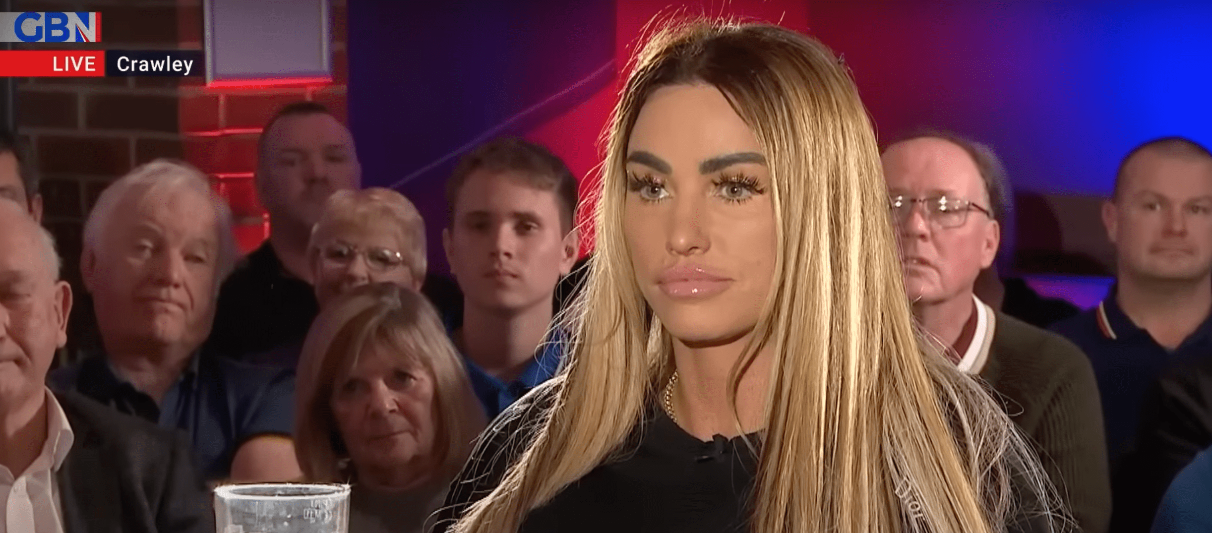 Katie Price looking straight faced with long blonde straight hair