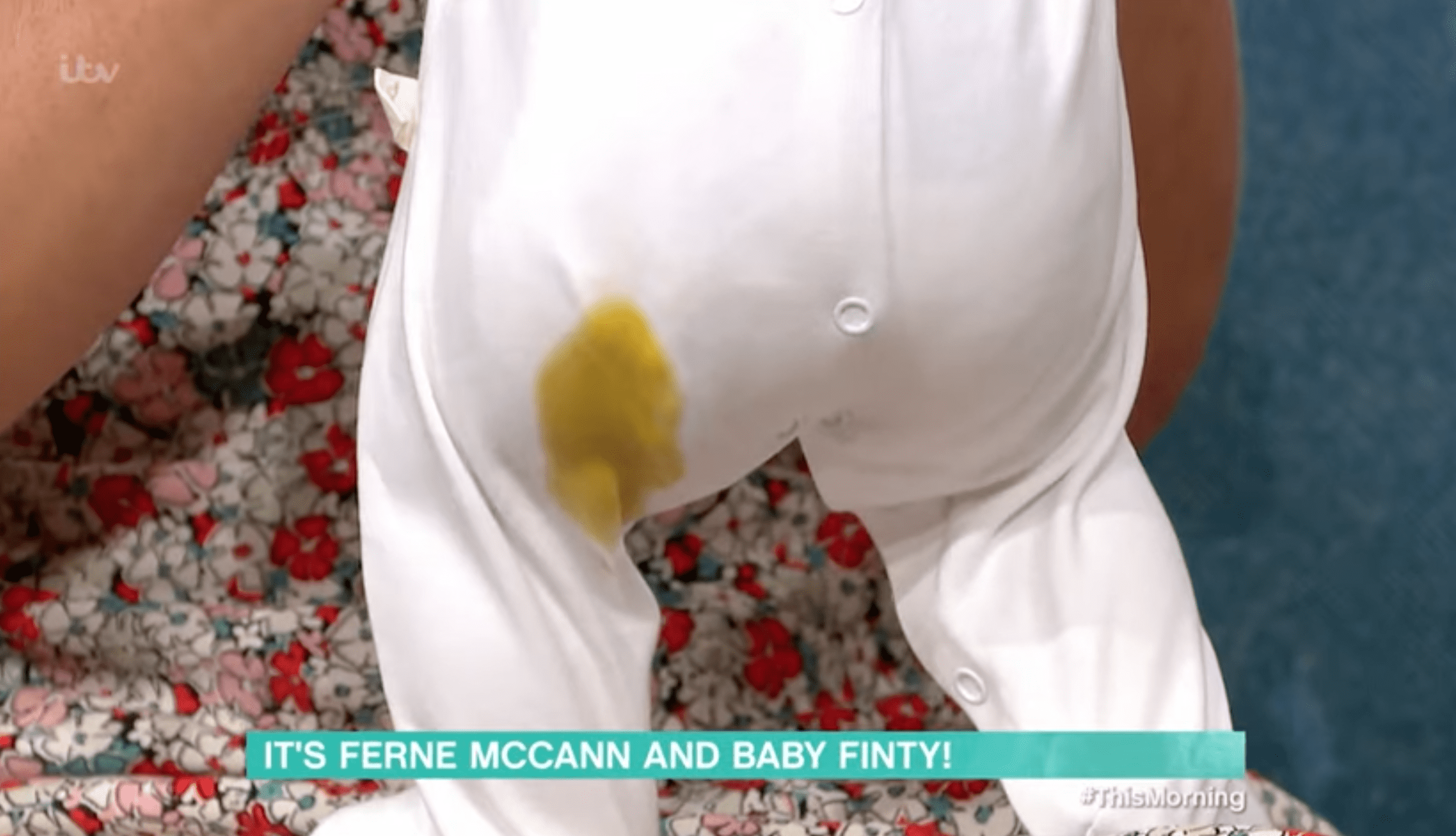 Close up of a baby's bum with poo on the babygro