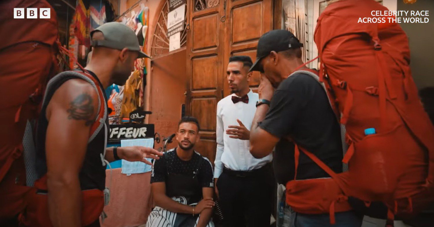 Alex Beresford asking locals while in Morocco for direction on BBC's Celebrity Race Across the World