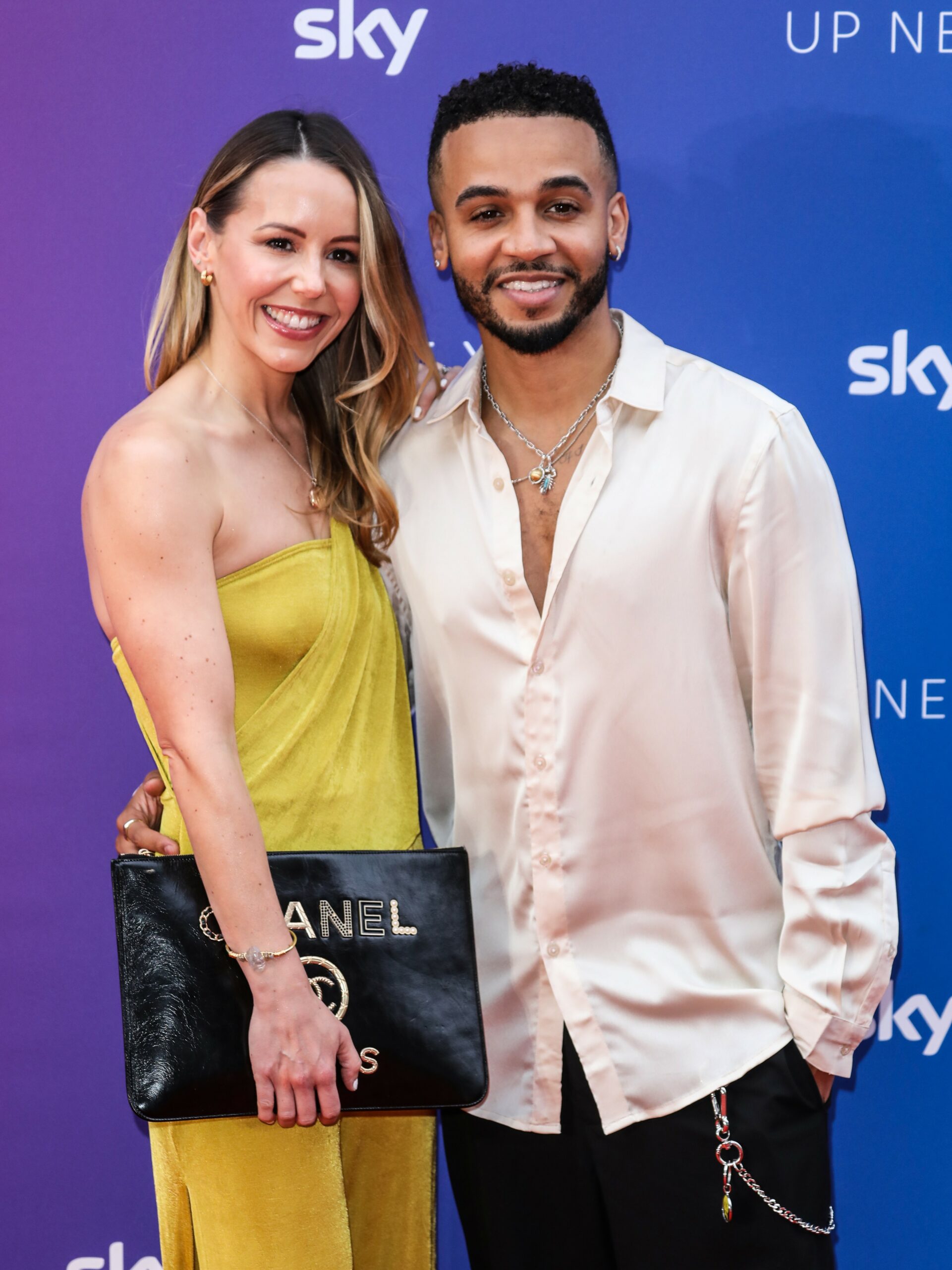 Aston Merrygold smiling with his wife at event