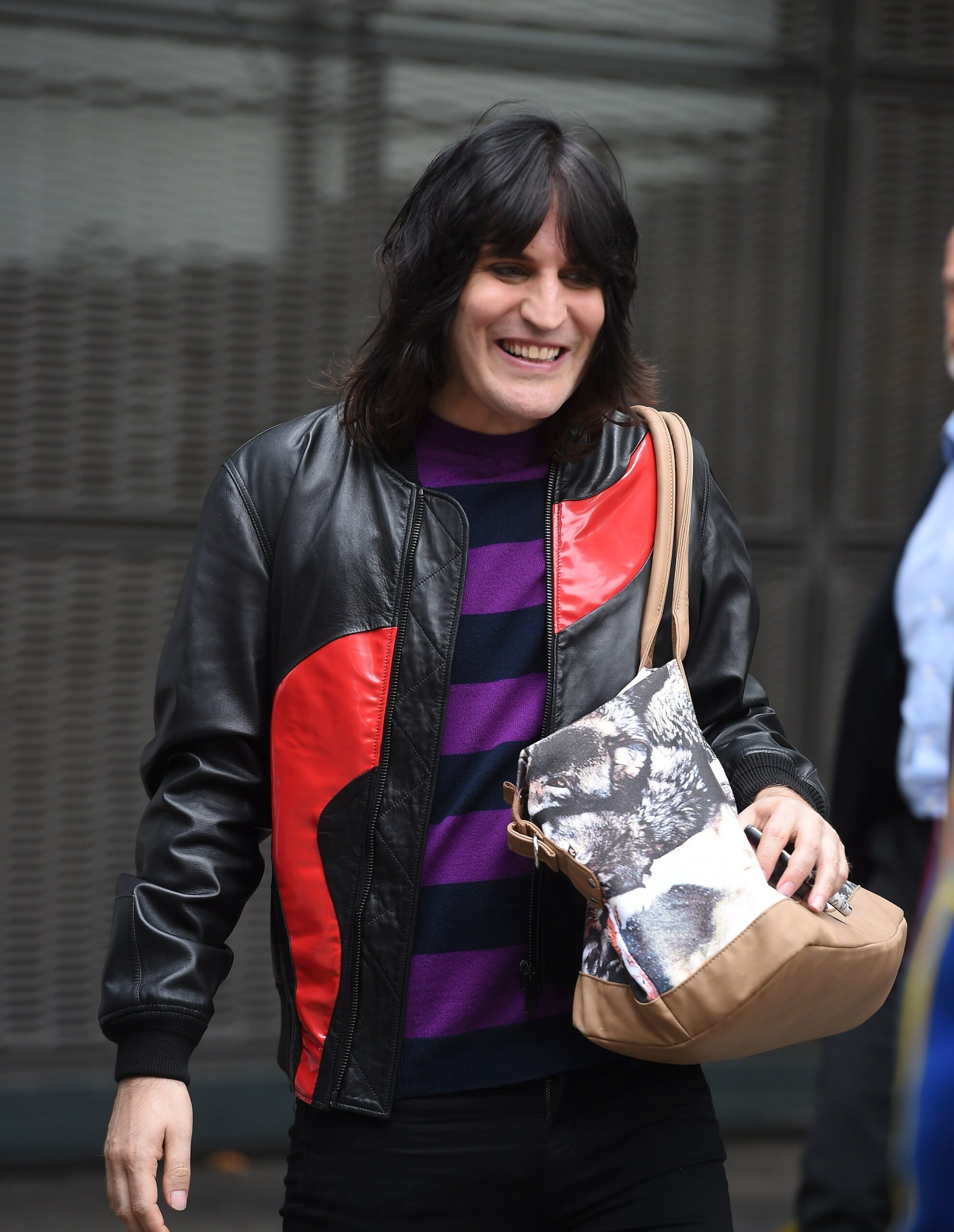 Bake Off host Noel Fielding smiling outside studios
