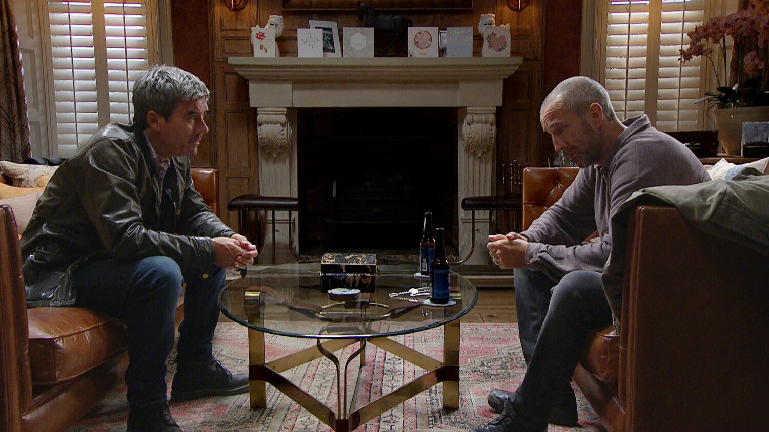 Emmerdale's Cain and Sam are sitting with each other at Home Farm