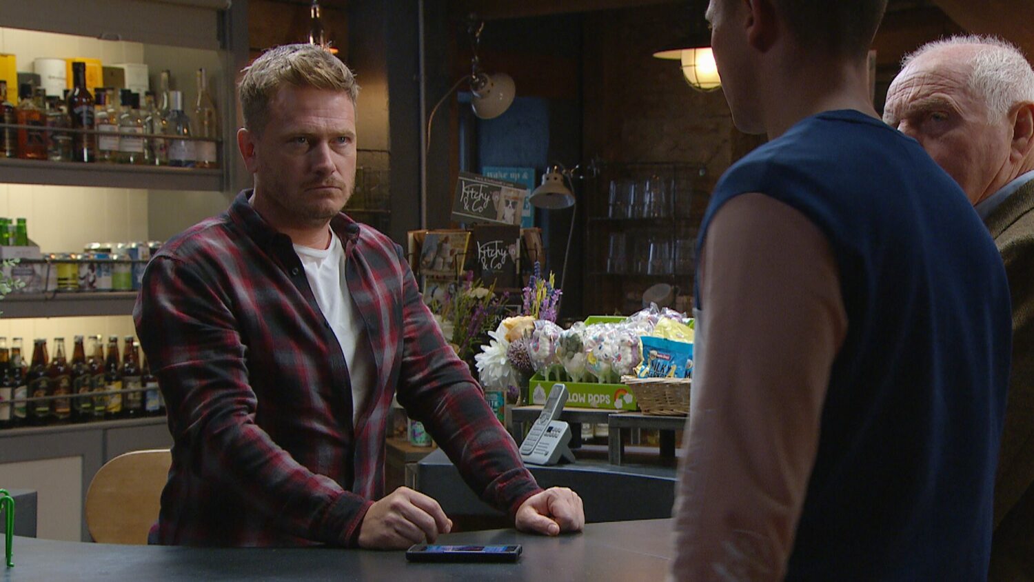 Emmerdale's David is talking to Jacob and Eric in the shop