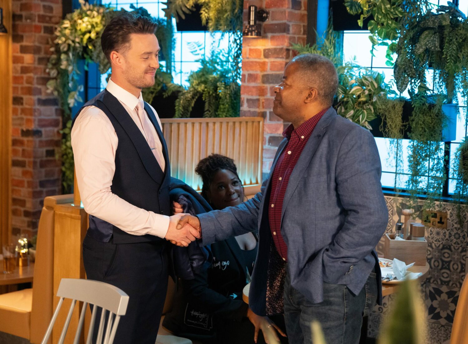 Corrie: Joel and Ed smile and shake hands