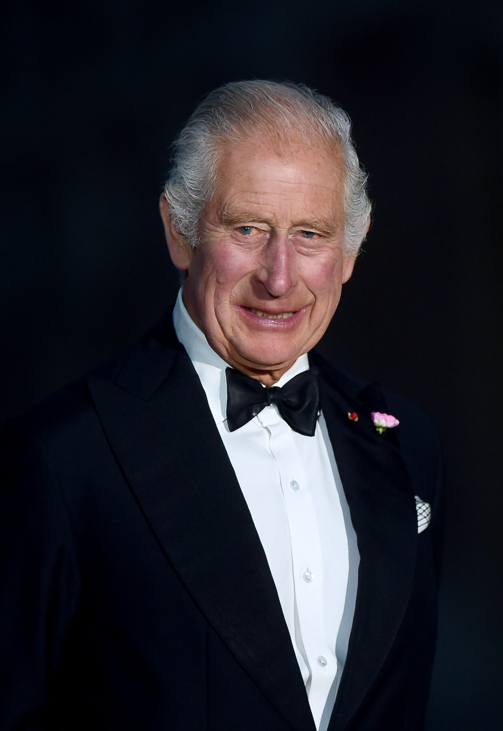 King Charles smiling in black tuxedo