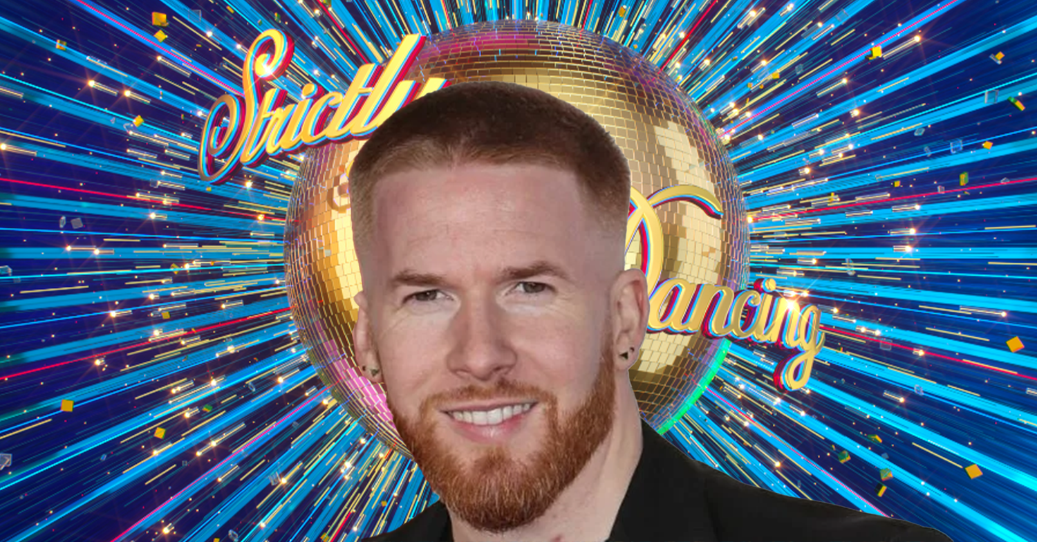 Neil Jones smiling against the Strictly logo