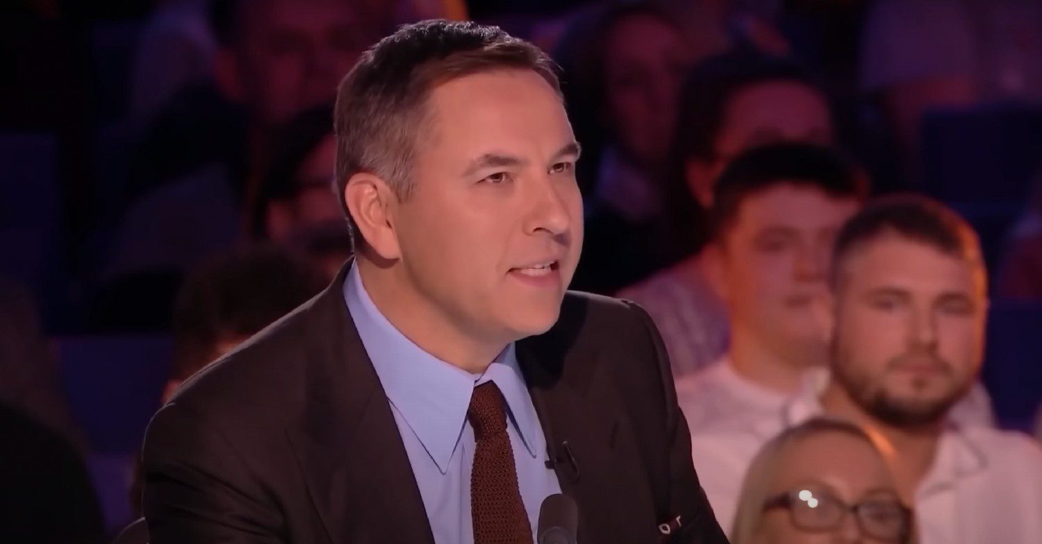 David Walliams sat judging on Britain's Got Talent wearing a dark suit and shirt and tie