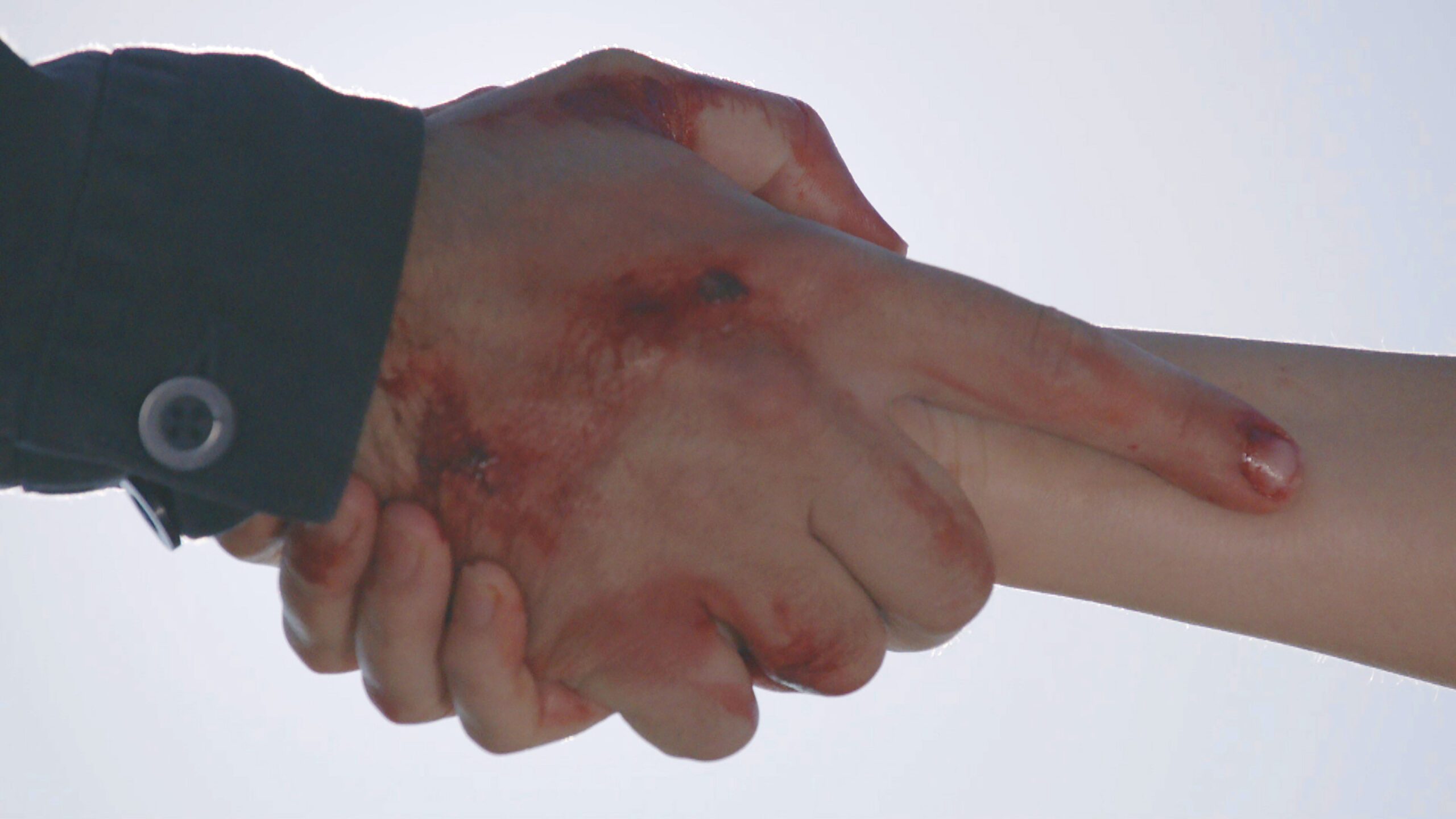 Mack's hand is holding another hand in Emmerdale