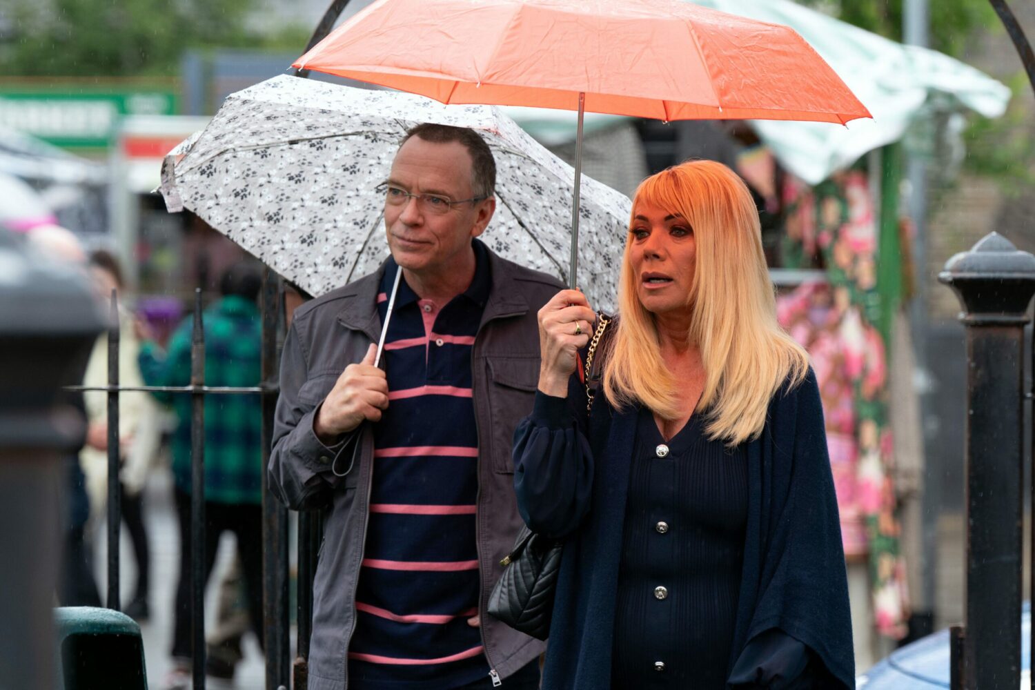 Ian Beale and Sharon Watts under umbrellas in the Square
