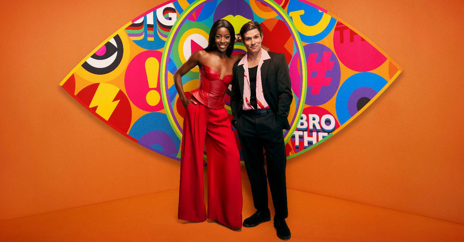 Big Brother host Aj Odudu and Will Best smiling as they stand in front of the show's logo