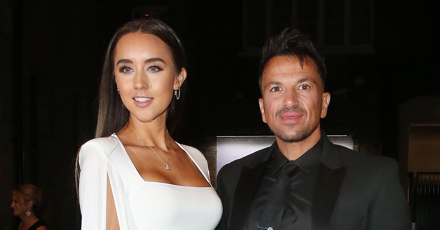 Peter Andre and wife Emily smiling at event