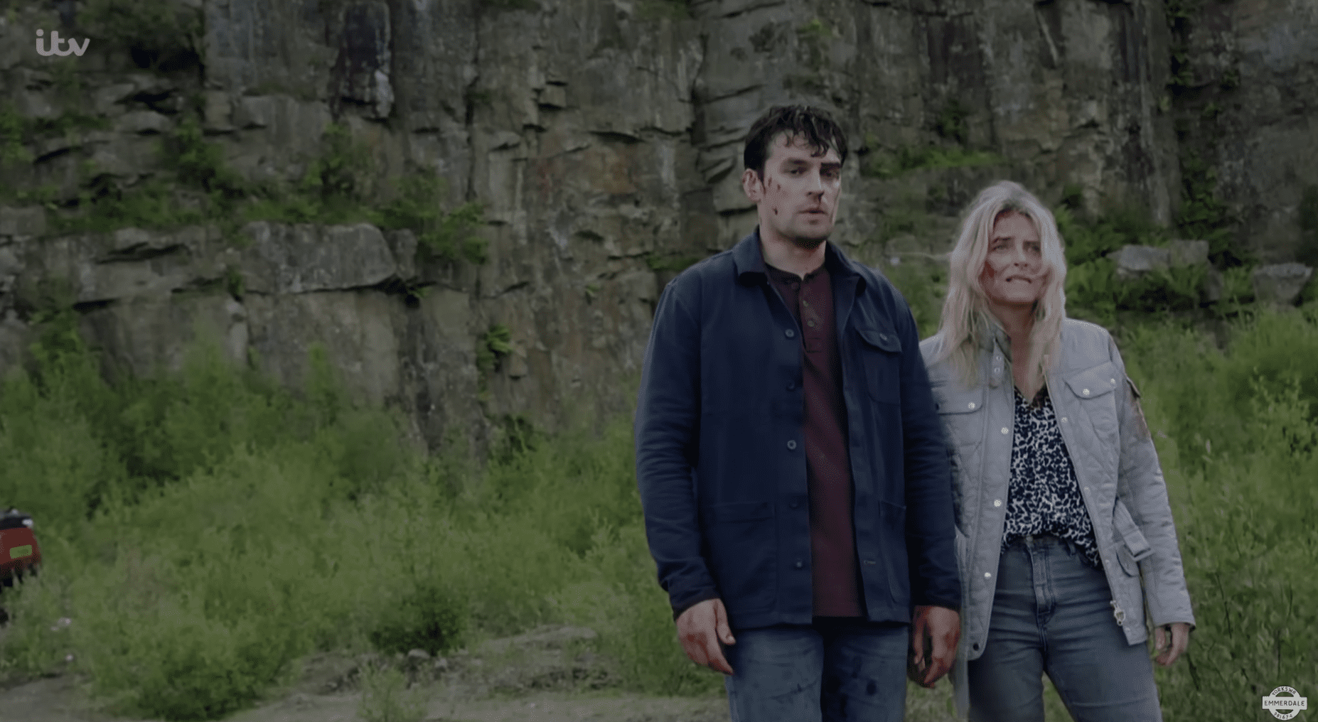 Mack and Charity stand together looking shaken, bloodied and scared 