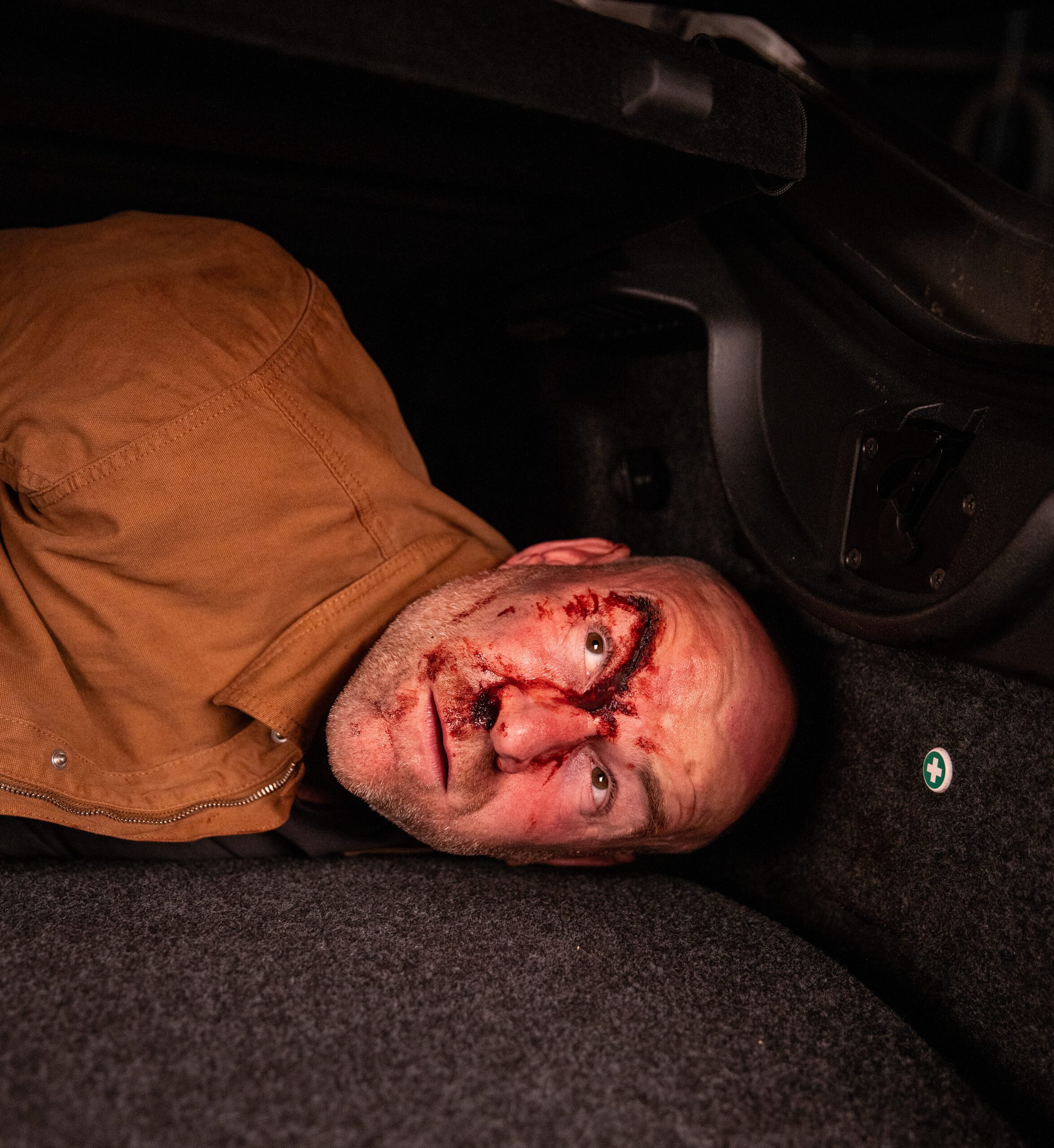 Tim looking scared in the boot of a car on Corrie