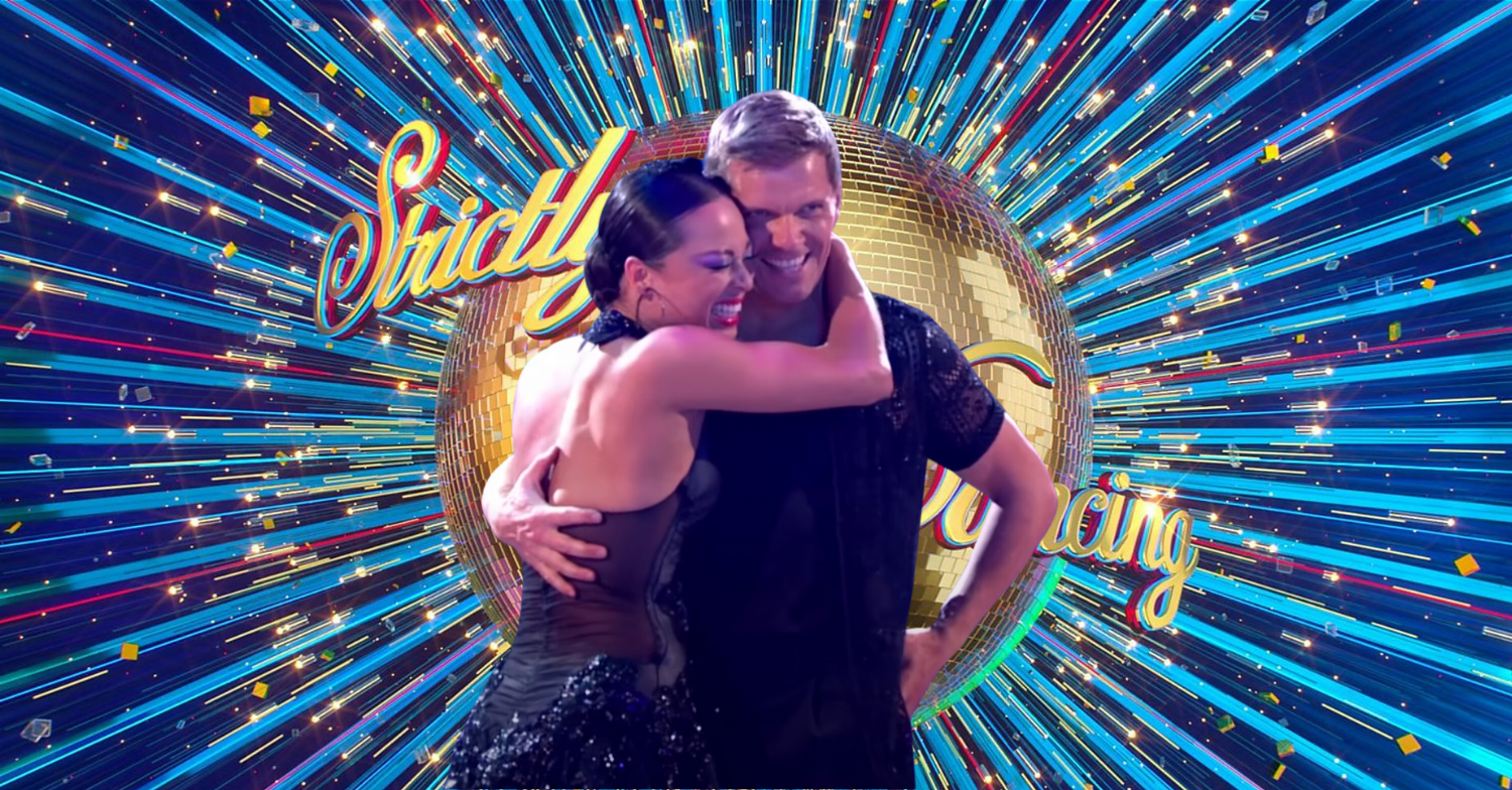 Nigel Harman and Katya Jones standing in front of the Strictly Come Dancing logo