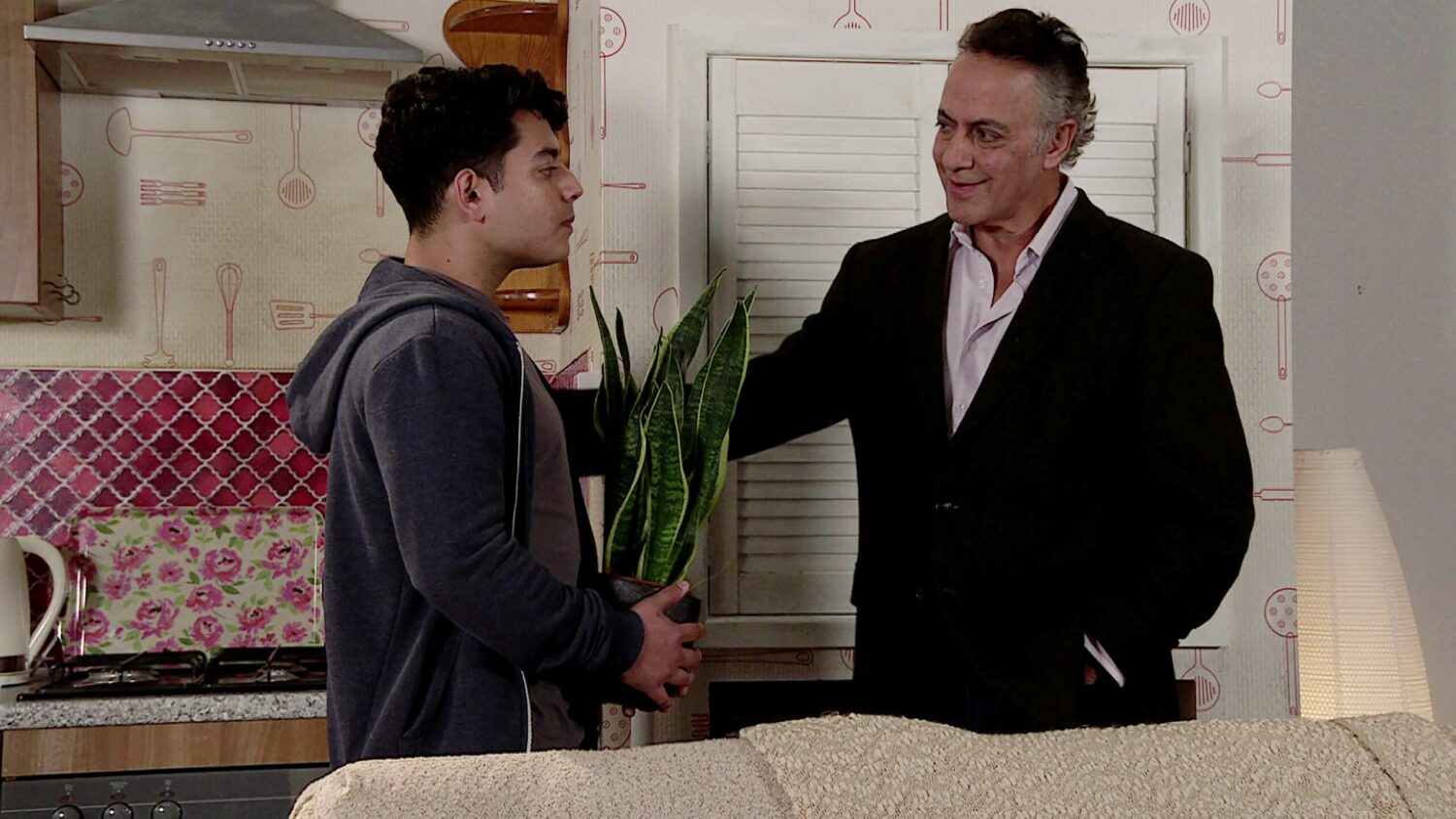 Dev puts his arm around son Aadi on Corrie (Credit: ITV)