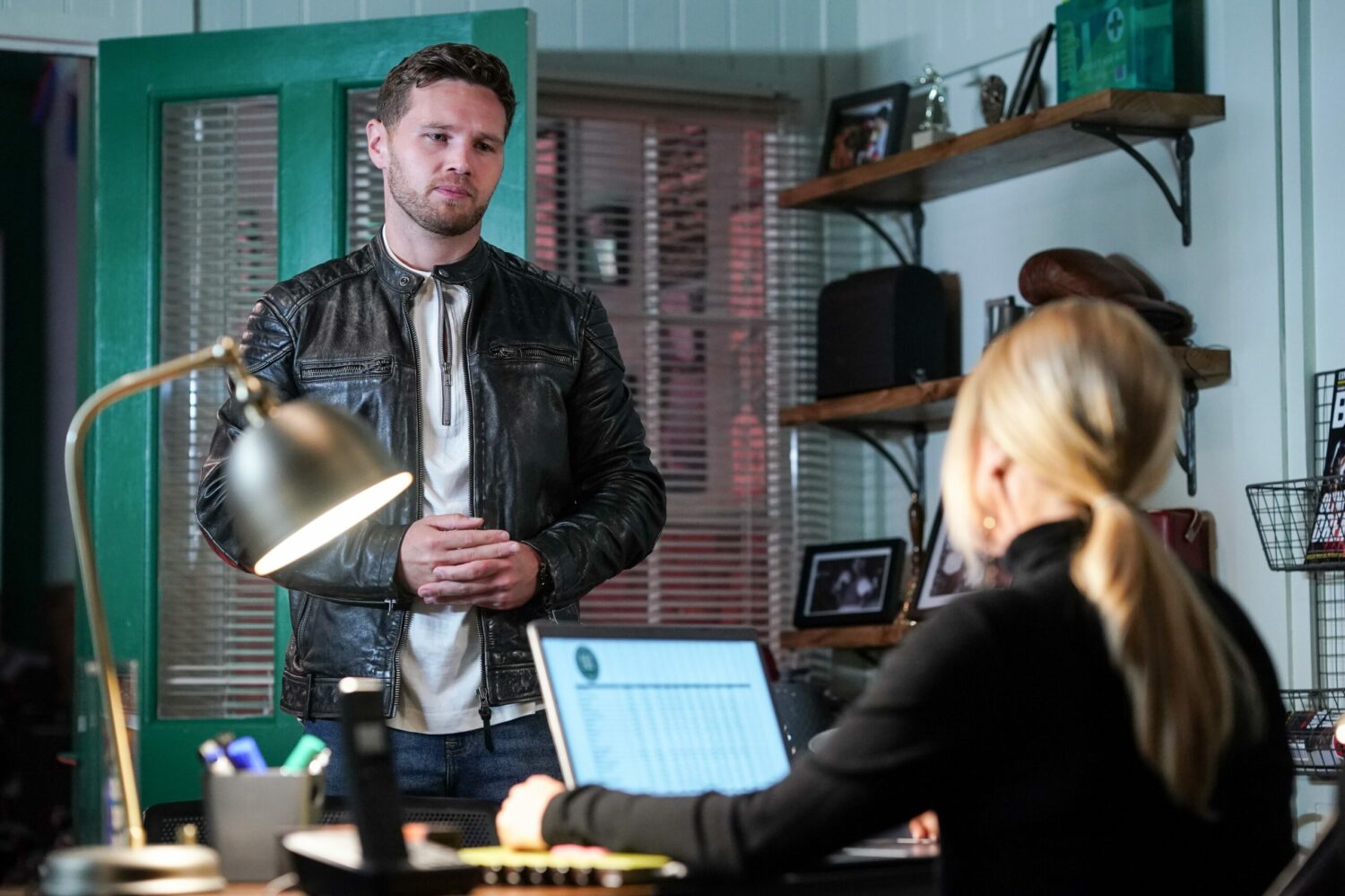 Keanu is talking to Sharon in the office