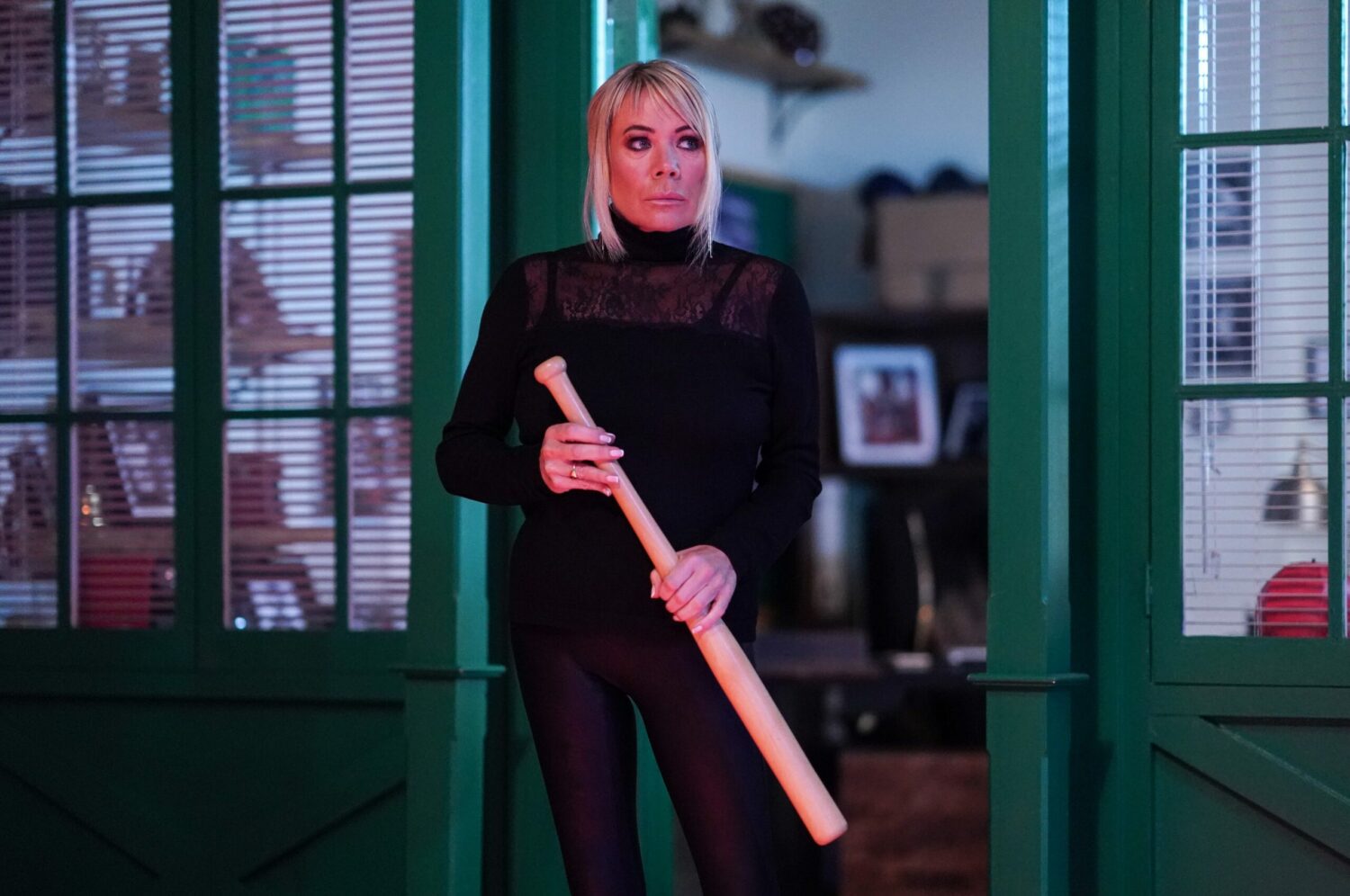 Sharon holding a baseball bat on EastEnders (Credit: BBC)