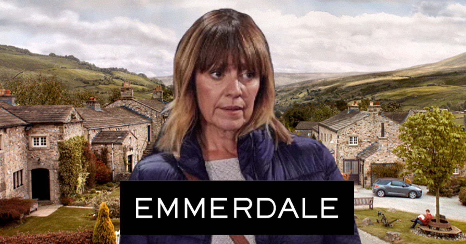 Rhona in front of Emmerdale village and logo