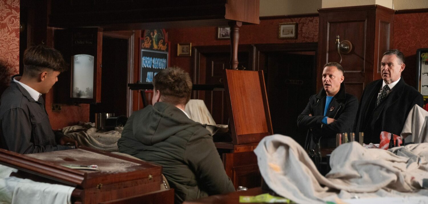 Sean and George looking angry as they confront the kids in the pub on Corrie