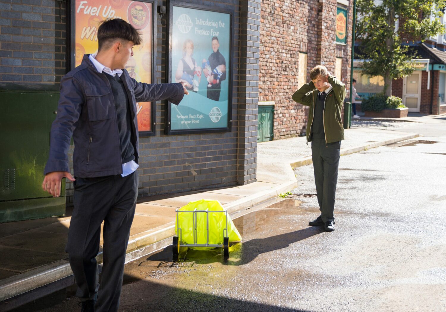 Dylan looks horrified as Mason throws his newspapers in a puddle on Corrie