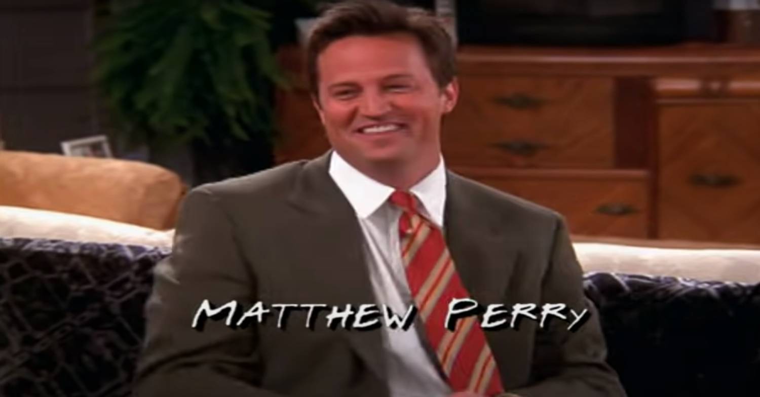 Matthew Perry smiles in character as Chandler Bing