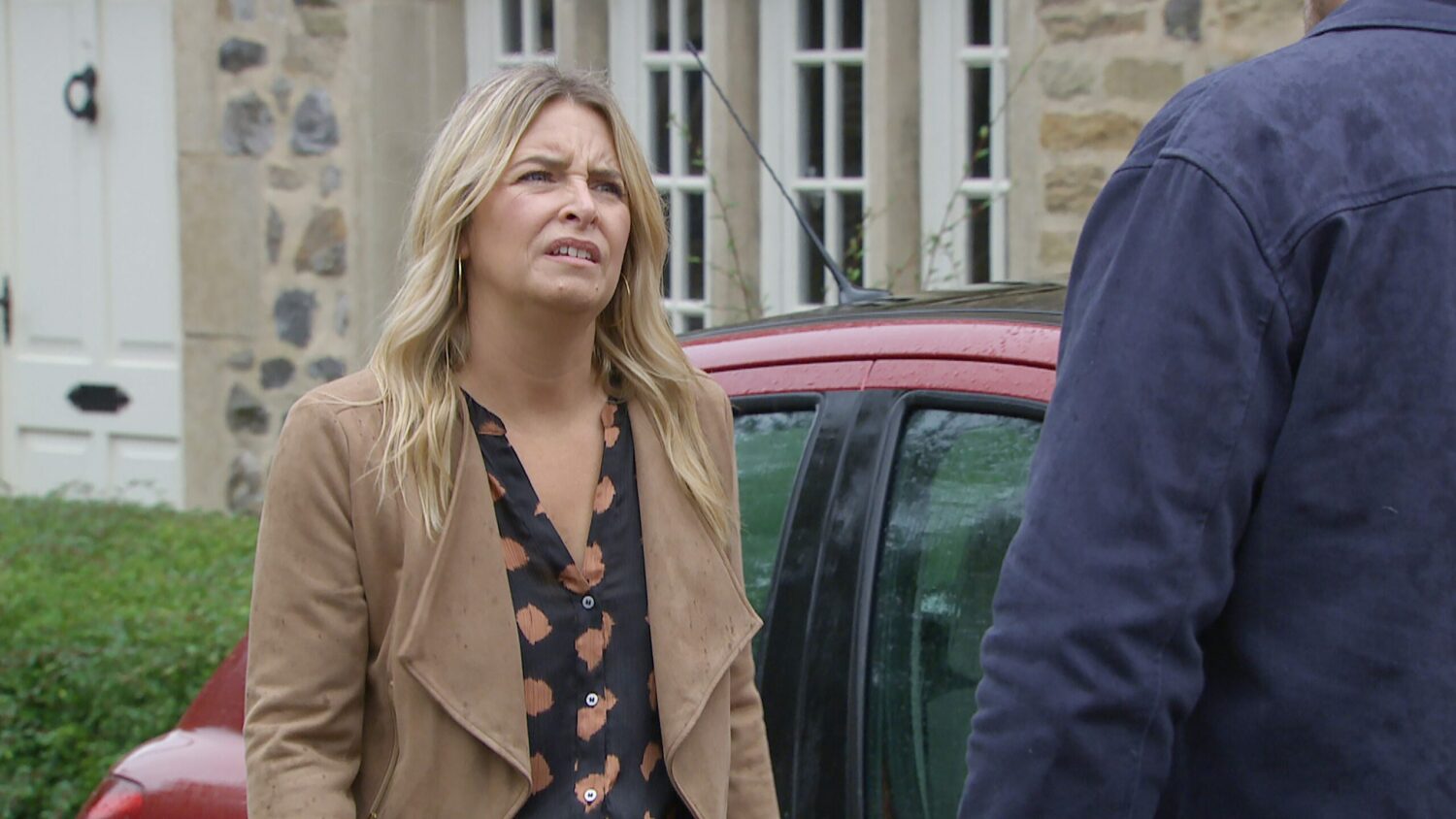 Charity grimaces as she talks to Mack