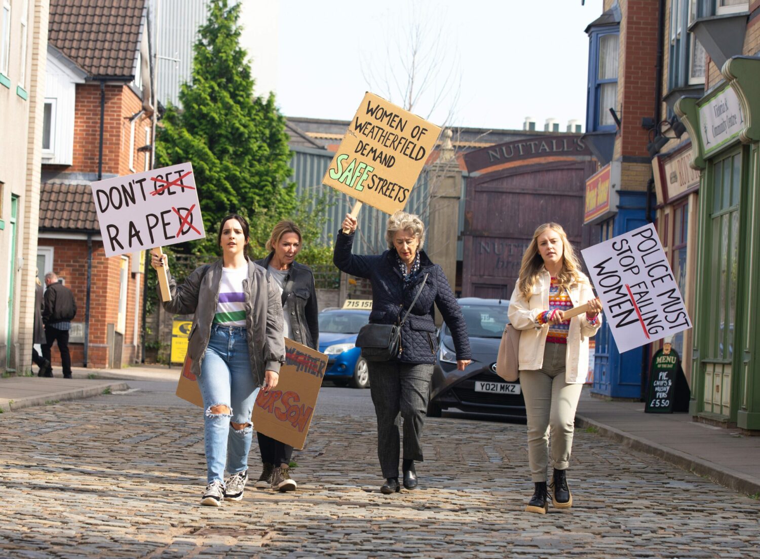 Corrie: Amy, Cassie, Evelyn and Summer wave placards and march in the street at the anti-spiking protest