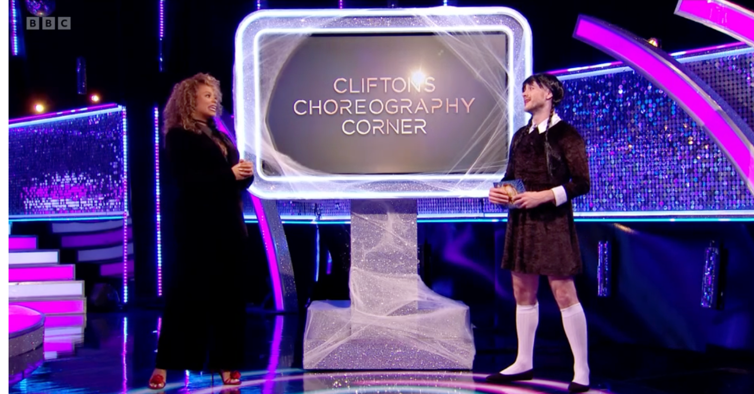 Dancer Kevin Clifton dressed as Wednesday Addams talking to Fleur East on Strictly: It Takes Two