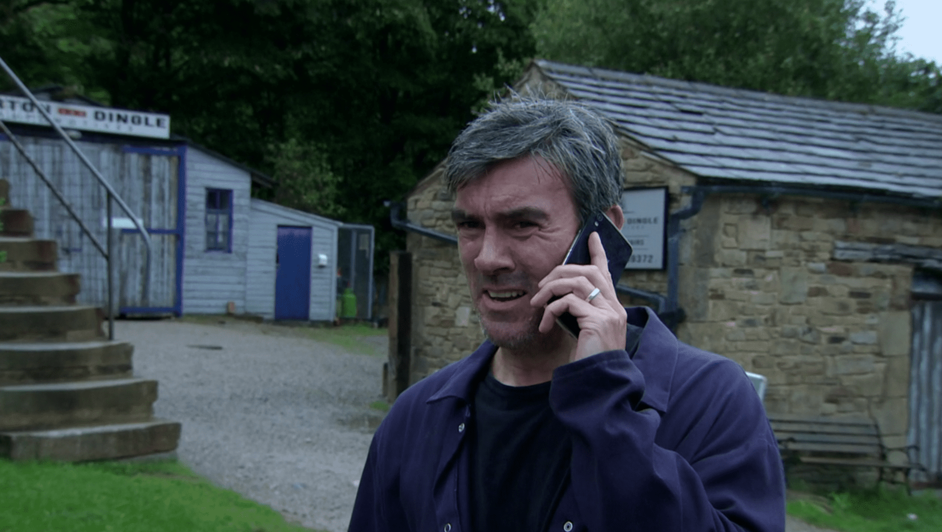 Emmerdale: Cain Dingle on the phone looking concerned