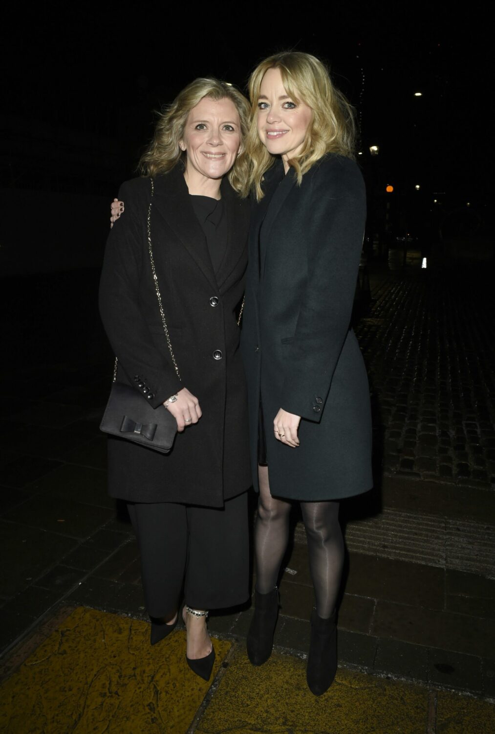 Jane Danson and Georgia Taylor smile together in black coats
