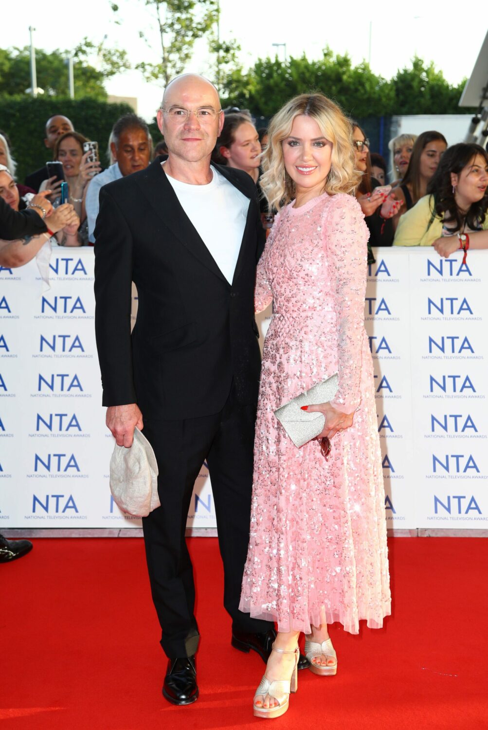 Joe Duttine and Sally Carman of Coronation Street smile as they pose on the NTA red carpet